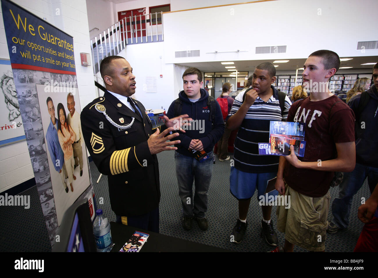 A Us Coast Guard Recruiter Talks With High School Students In