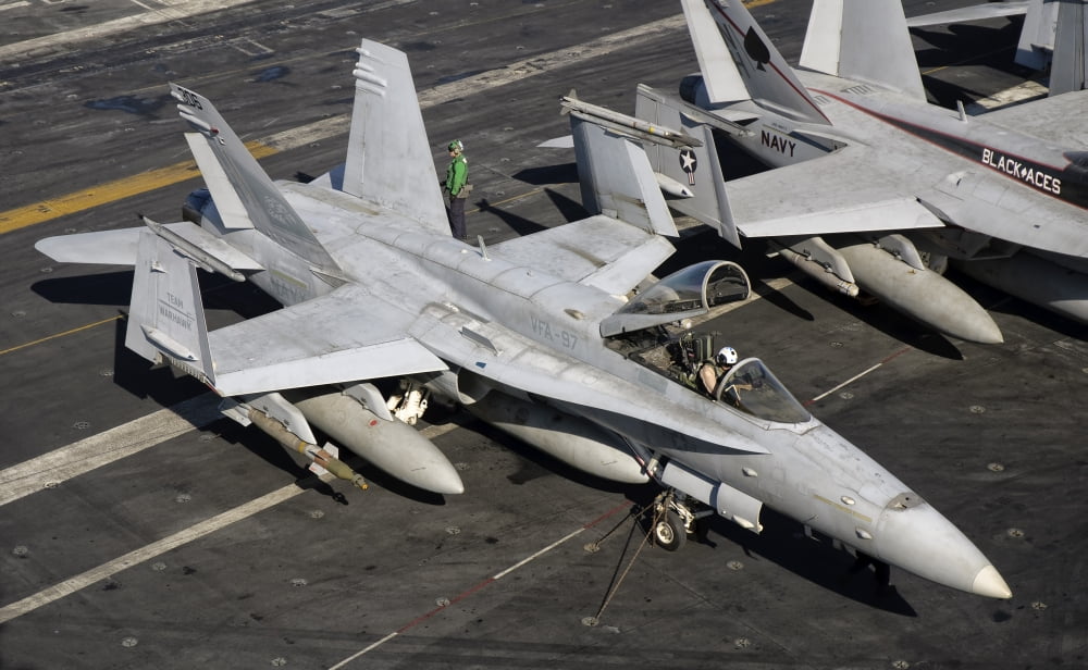 A Us Navy F A 18C Hornet Parked On The Flight Deck Of Aircraft Carrier