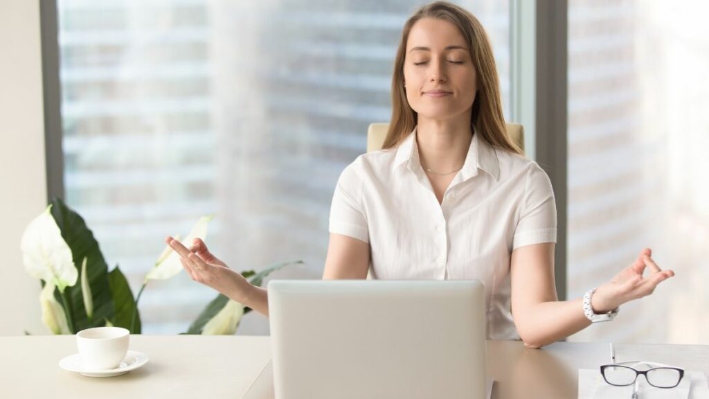 woman practicing mindfulness at desk