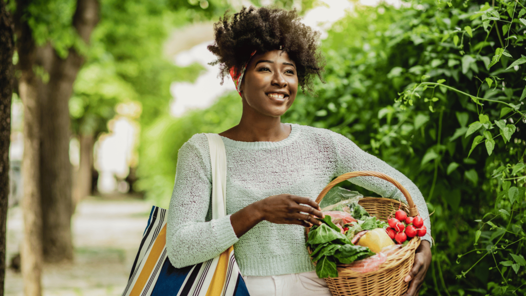 woman carrying basket of healthy food.